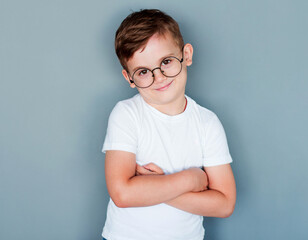 Wall Mural - Portrait of young boy wearing glasses, studio