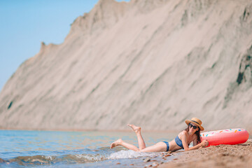 Young woman in white on the beach