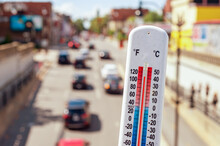 Thermometer In Front Of Cars And Traffic During Heatwave In Montreal.