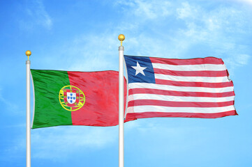 Portugal and Liberia two flags on flagpoles and blue sky