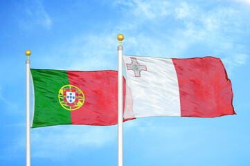 portugal and malta two flags on flagpoles and blue sky