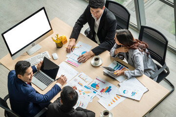 Business people group meeting shot from top view in office . Profession businesswomen, businessmen and office workers working in team conference with project planning document on meeting table .