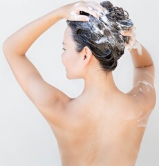 Wall Mural - Sexy woman washing her hair in the bathroom.