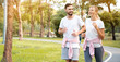 © Rapeepat - Couple are running happy in the garden. Family Workout activity during the holiday. Safe and clean exercise places for the health of people who use the place. Concept sport health