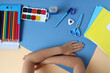 © MARYIA - Folded child's hands on the table with school supplies-the concept of starting school classes