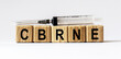 © Stanislau - Text CBRNE made from wooden cubes. White background