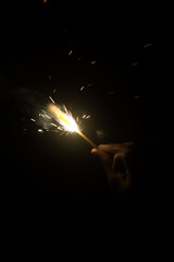 Buring sparkler matchstick in hands	
