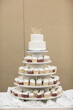 canvas print picture - tiered wedding cake on stand with cupcakes