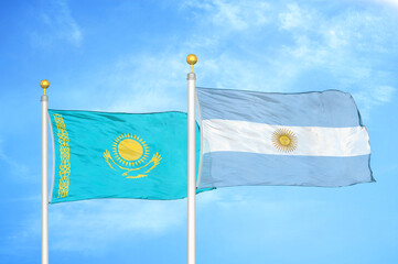 Kazakhstan and Argentina two flags on flagpoles and blue sky