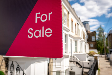 Wall Mural - Estate agent 'For Sale' sign on street of houses