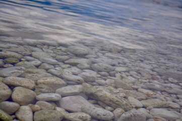 rocks  and pebbles in the transparent sea on the beach