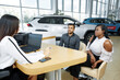 © Юрий Дровнин - Visiting a car dealership. A young African-American couple to communicate with the agent for the sale of the car. Selective focus