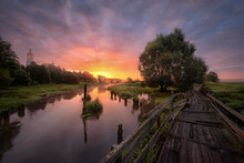 Dawn In The Village Of Filippovskoye On A Wooden, Crooked Bridge Over The Sherna River