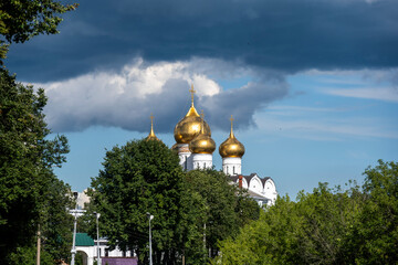 white stone old buildings with golden domes against the blue sky