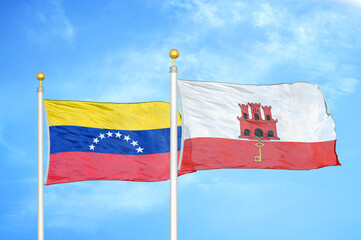 Venezuela and Gibraltar two flags on flagpoles and blue sky