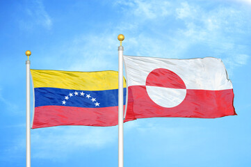 Venezuela and Greenland two flags on flagpoles and blue sky