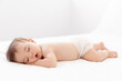 © Lisa Tichané - Full body shot of sleeping baby on white bed