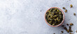 Green tea oolong in a clay tea cup bowl. Grey stone background. Copy space. Top view.