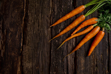 carrots on a dark wooden table, vegetables from the garden. Healthy eating.