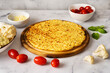© Katecat - Healthy cauliflower pizza crust with ingrediets on white background