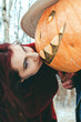 witch and a Halloween pumpkin kiss