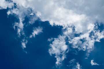 floating white cloud in bright blue sky in sunny day