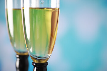 Background with tall glasses for sparkling wines. Champagne and spray in glass glasses. Celebratory drink with reflection.