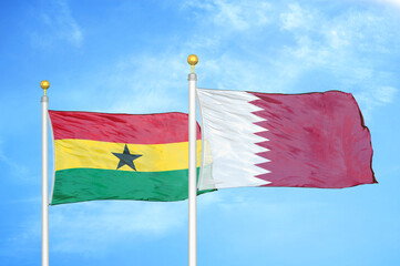 Ghana and Qatar two flags on flagpoles and blue sky