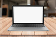 © DEEP PIXEL - Laptop with blank screen on wooden table with bokeh restaurant backgound