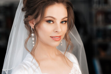 portrait of a beautiful bride with makeup and hair styling smiling