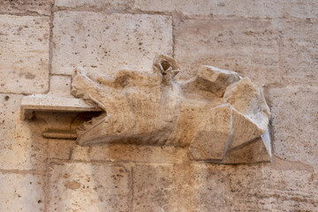 Gothic gargoyle bas relief on an ancient historical building in Valencia