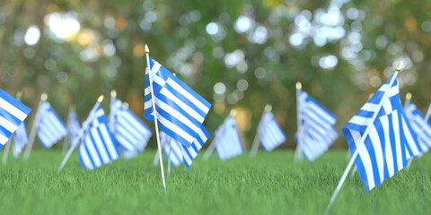 Flags of Greece in the grass. National holiday related 3D rendering