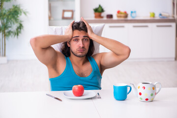 Canvas Print - Young man waking up at home