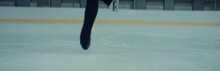 CU On Skates, Professional Female Ice Figure Skater Performing Spin On Ice. Shot On RED Cinema Camera With 2x Anamorphic Lens