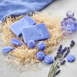 Homemade lavender soap bars and candy shaped soap, lavender extract bottle and dry lavender flowers. Top view.