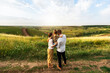 © Prostock-studio - Happy family enjoying beautiful landscape outdoors in the field