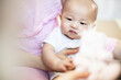 © anon - Asian baby happy in the room.Asian baby girl lying down on bed .