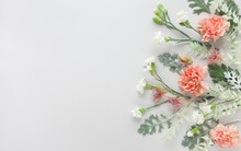 White And Coral Flowers  And Silver-green Leaves  On Pastel Grey Background. Flowers Composition With Copy Space, Flat Lay.