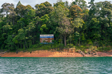 Direction signboard on a small island in Kenyir Lake, Malaysia. Tasik Kenyir is a man made lake.