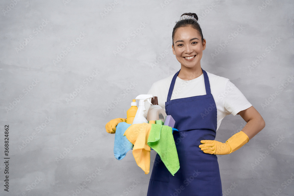 Portrait of a happy young woman, cleaning lady in uniform with bucket ...