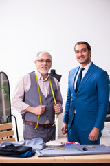 Young businessman visiting old male tailor