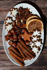 Wall Mural - spices and christmas cookies on a dish, top view closeup