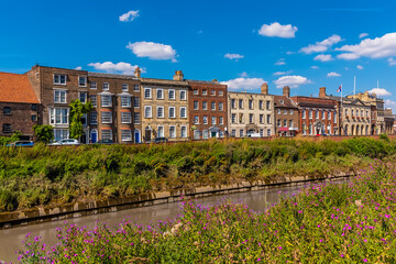 Wall Mural - A view along the River Nene towards Georgian buildings on the North Brink in Wisbech, Cambridgeshire in the summertime