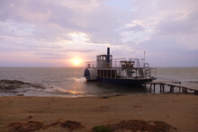 Paddle Wheel Ship On The Pier At Sunset