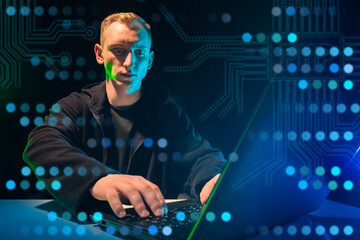 technical specialist. programmer at the computer on a technical task. a man is working at a computer