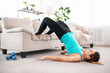 © Admiral - Fitness girl doing yoga exercise is using furniture for workout at home. Indoors training in living room. Copy space