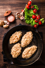 Sticker - Chicken cutlets in a pan on a dark concrete table background