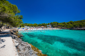 CALA MONDRAGO, Majorka, Spain, 24 July 2020 - People enjoy the beach in summer, Parque Natural de Mondrago. Santanyi. Malorca. Spain