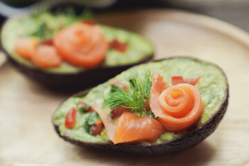 Avocado boats stuffed with smoked salmon rose salad, healthy low carb ketogenic food