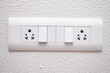 © deep - DESIGNER ELECTRICAL SWITCH BOARD WITH 3 PIN SOCKET AND TWO SWITCH ON THE WHITE WALL